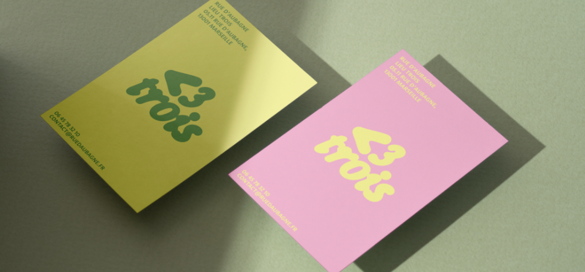 Emblem design for Madame FC depicting an M monogram in a circle with the words "Madame FC EST. 2003" inside on top of a background image of a soccer stadium.